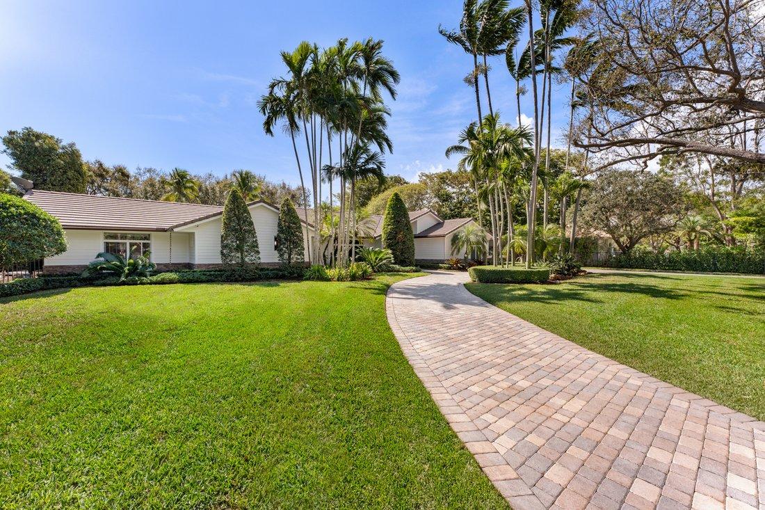 South Florida home with maintained lawn and driveway